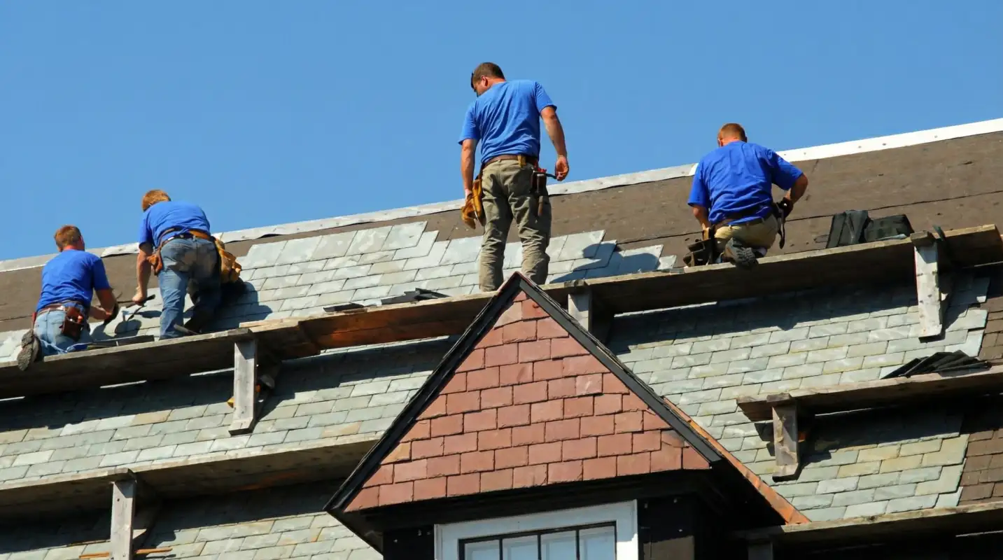 Roof replacement in progress with a team of professional contractors installing new shingles on a residential home in Chicago, IL