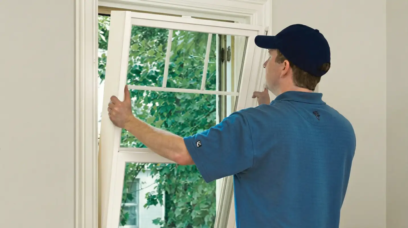 Professional contractors performing a residential window insulation and replacement service in Chicago, IL